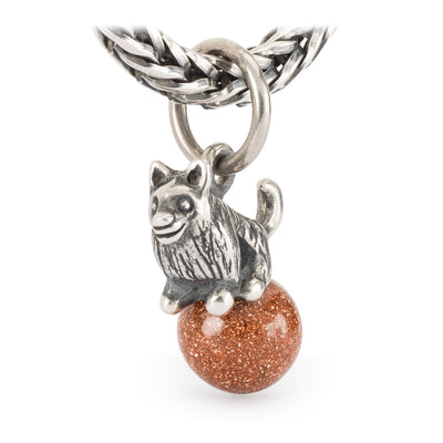Jewellery silver pendant of a long haired dog on a ball of goldstone.